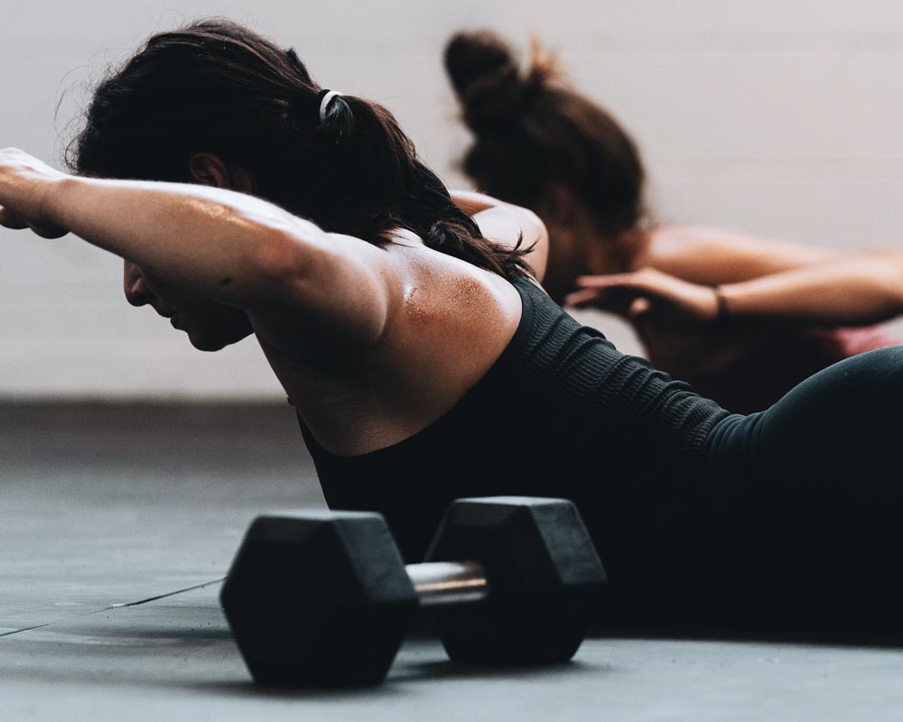 Two women training with weights.